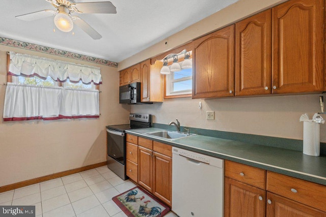 kitchen featuring stainless steel electric range oven, white dishwasher, brown cabinets, black microwave, and a sink