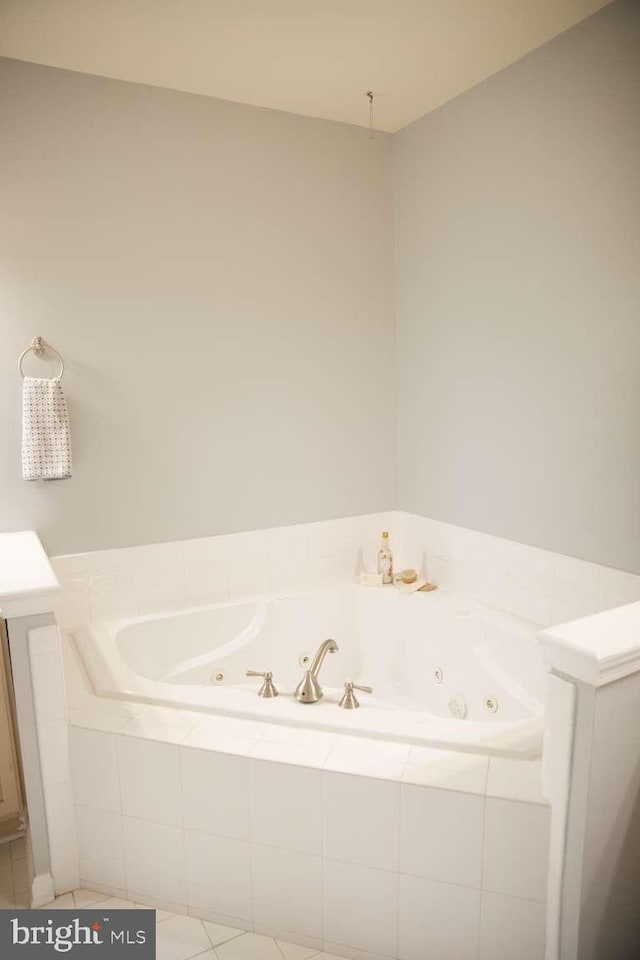 full bath with tile patterned flooring and a whirlpool tub
