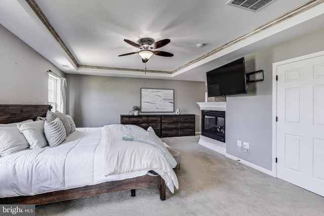 5701 Wink Way, Woodbridge, VA 22193 - bedroom featuring carpet flooring, baseboards, visible vents, a glass covered fireplace, and a raised ceiling