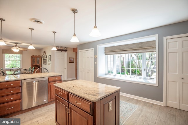1701 Holicong Rd, New Hope, PA 18938 - kitchen with stainless steel dishwasher, visible vents, brown cabinetry, and light wood-type flooring