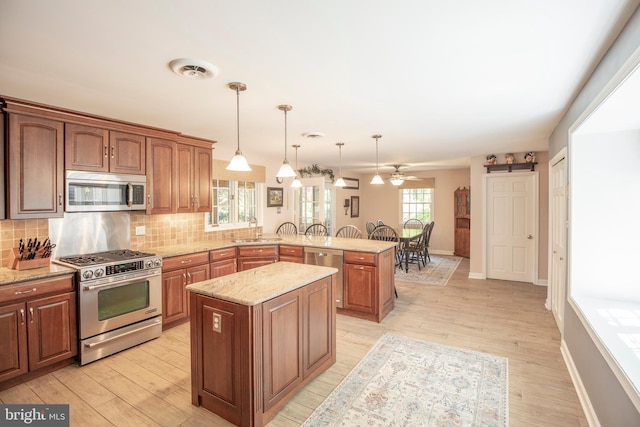 1701 Holicong Rd, New Hope, PA 18938 - kitchen featuring ceiling fan, decorative backsplash, appliances with stainless steel finishes, a sink, and a peninsula