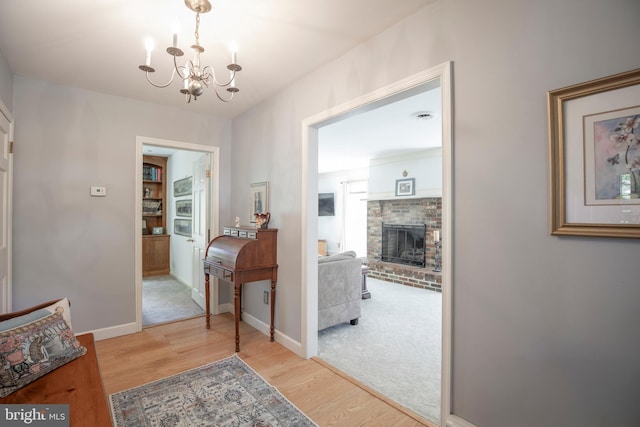 1701 Holicong Rd, New Hope, PA 18938 - hall featuring baseboards, an inviting chandelier, wood finished floors, and carpet