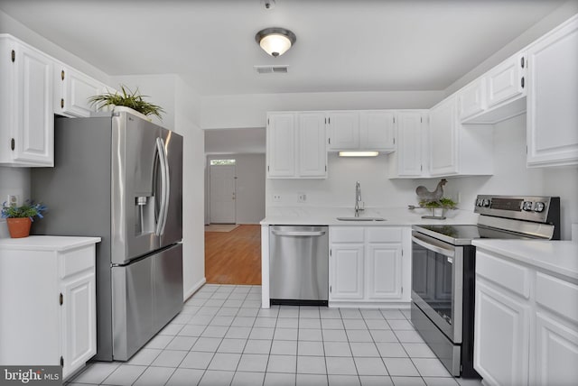 4223 N Carlin Springs Rd, Arlington, VA 22203 - kitchen featuring appliances with stainless steel finishes, light countertops, white cabinetry, and light tile patterned floors