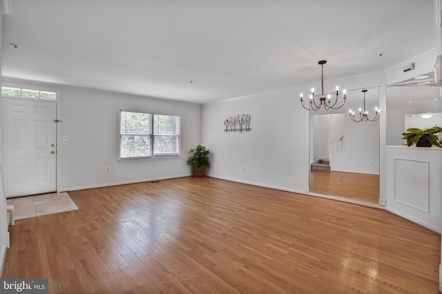 4223 N Carlin Springs Rd, Arlington, VA 22203 - entrance foyer featuring a chandelier, light wood finished floors, and stairs