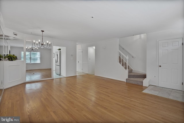 4223 N Carlin Springs Rd, Arlington, VA 22203 - unfurnished living room with a chandelier, light wood-style floors, and stairway