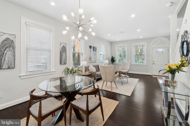 dining space with baseboards, recessed lighting, a notable chandelier, and dark wood finished floors