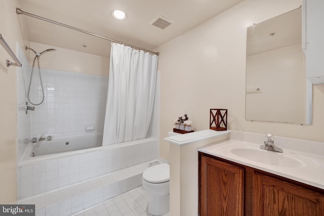 full bath with tile patterned floors, tiled shower / bath, toilet, vanity, and visible vents