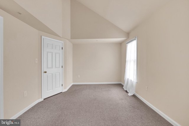 interior space with vaulted ceiling and baseboards