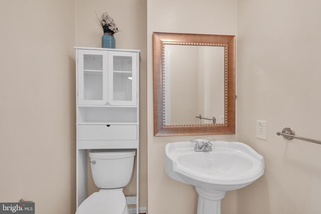bathroom with toilet and a sink