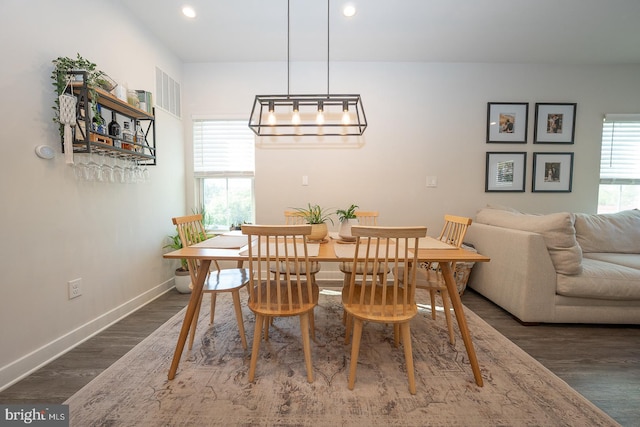 dining space with dark wood-style flooring, baseboards, and recessed lighting