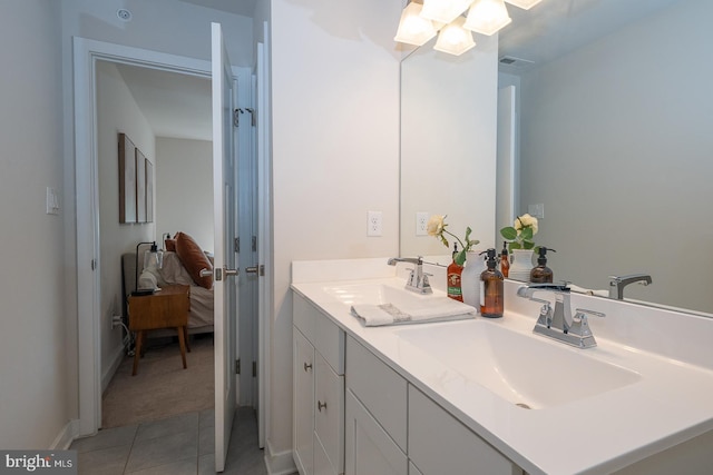 full bath with double vanity, a sink, tile patterned floors, and visible vents