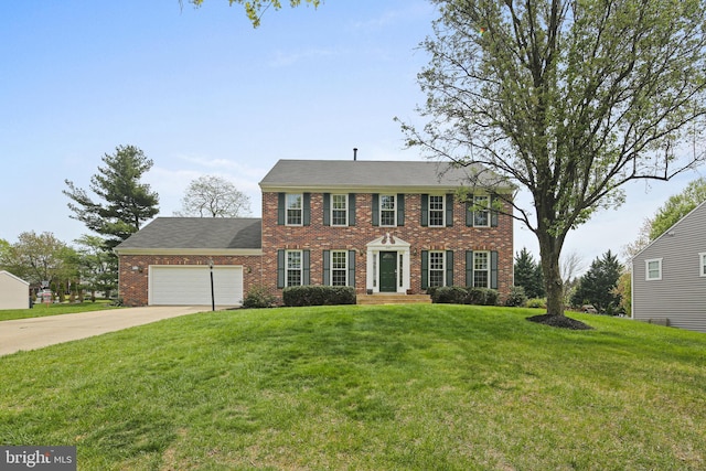 colonial home with a garage, driveway, a front lawn, and brick siding