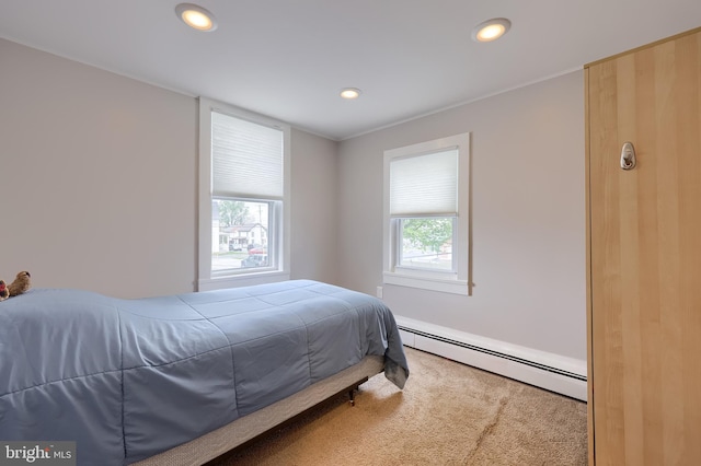 carpeted bedroom featuring recessed lighting and a baseboard radiator