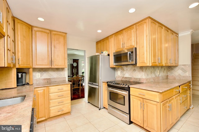 kitchen featuring light stone countertops, tasteful backsplash, stainless steel appliances, and recessed lighting