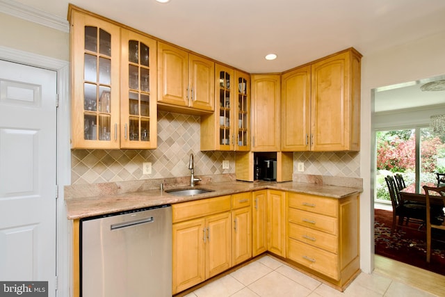 kitchen with light stone counters, decorative backsplash, stainless steel dishwasher, glass insert cabinets, and a sink
