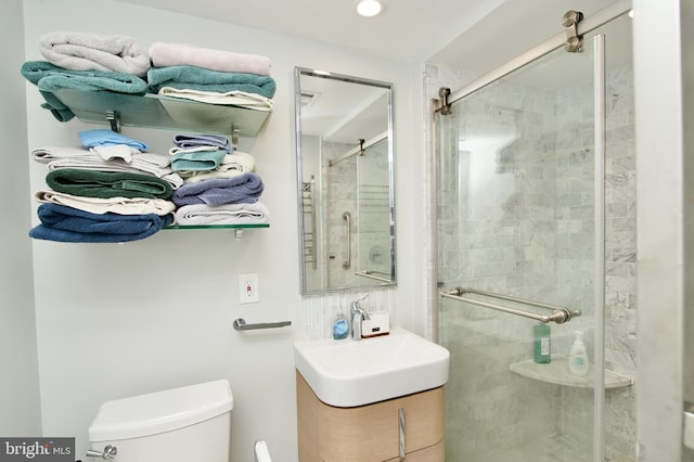 full bathroom featuring vanity, toilet, and a stall shower