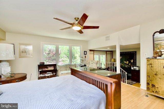 bedroom with visible vents, wood finished floors, and ceiling fan