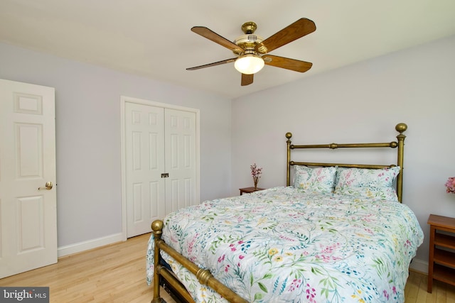 bedroom with a closet, ceiling fan, baseboards, and light wood-type flooring