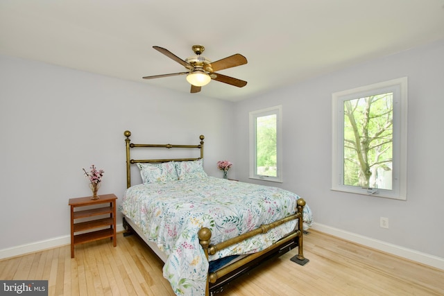 bedroom featuring wood finished floors, ceiling fan, and baseboards