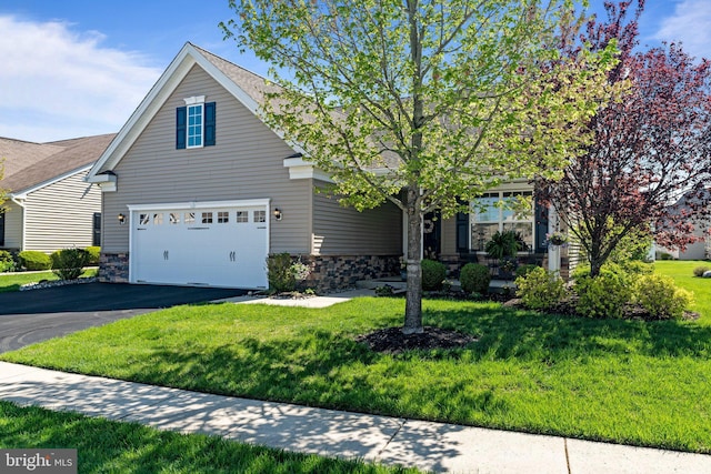 view of front of home featuring a garage, a front yard, driveway, and stone siding