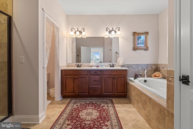 full bathroom with a garden tub, a sink, tile patterned floors, and double vanity