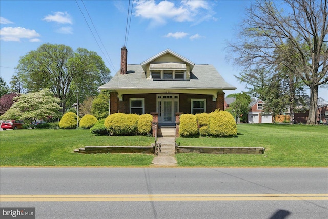 103 Pleasure Rd, Lancaster, PA 17601 - bungalow featuring covered porch, brick siding, a chimney, and a front yard