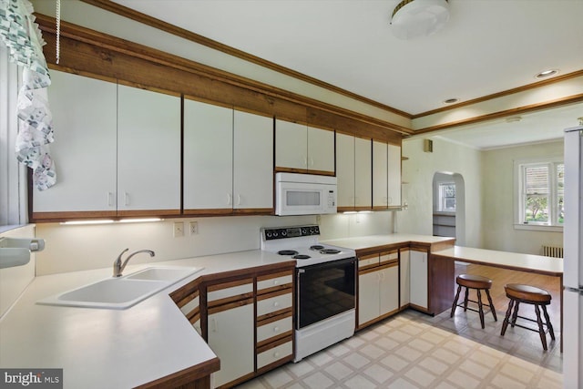 103 Pleasure Rd, Lancaster, PA 17601 - kitchen with crown molding, arched walkways, a sink, light floors, and white appliances