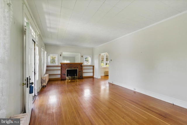 103 Pleasure Rd, Lancaster, PA 17601 - living area with arched walkways, a wealth of natural light, radiator heating unit, and wood finished floors
