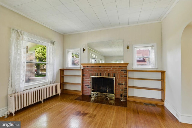 103 Pleasure Rd, Lancaster, PA 17601 - living area featuring ornamental molding, radiator, a fireplace, and hardwood / wood-style flooring