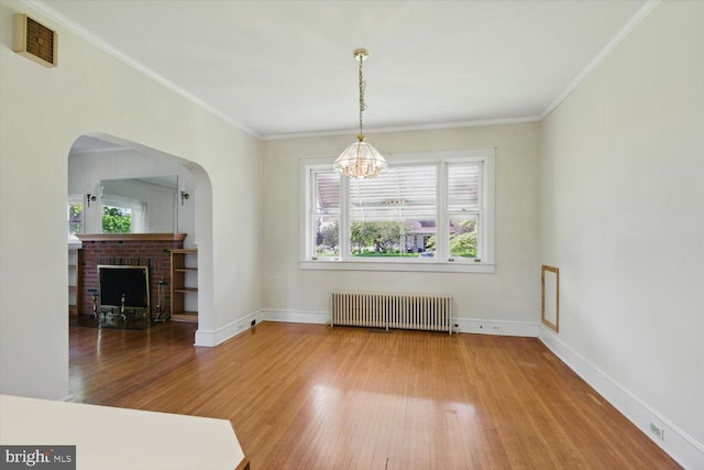 103 Pleasure Rd, Lancaster, PA 17601 - unfurnished dining area with an inviting chandelier, radiator, wood finished floors, and a healthy amount of sunlight