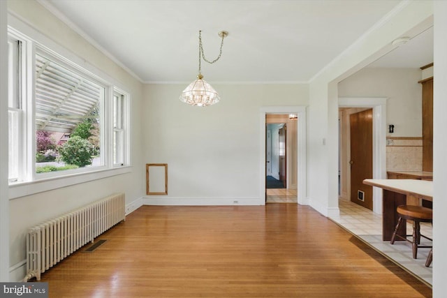 103 Pleasure Rd, Lancaster, PA 17601 - unfurnished dining area with crown molding, an inviting chandelier, radiator heating unit, light wood-style flooring, and baseboards