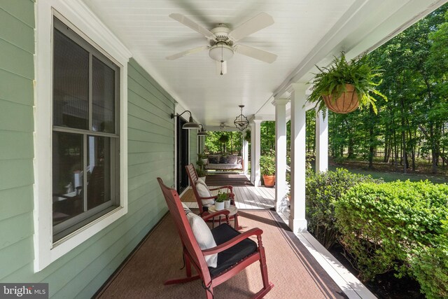 view of patio featuring ceiling fan and a porch