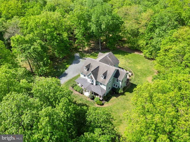 birds eye view of property with a forest view
