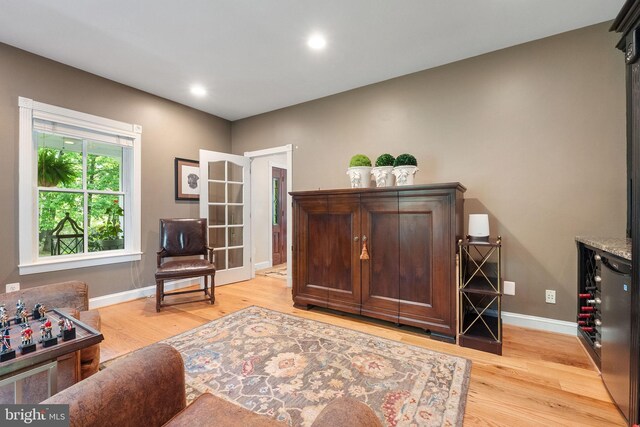 sitting room with baseboards, recessed lighting, and light wood finished floors