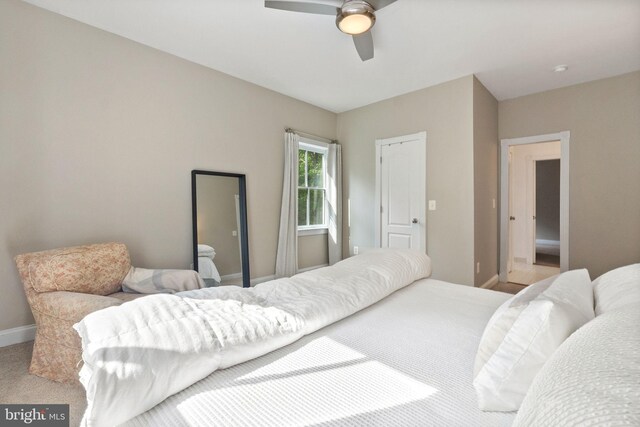 carpeted bedroom with baseboards and ceiling fan