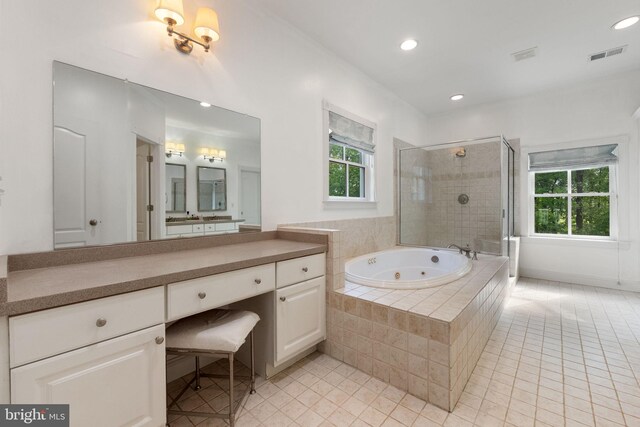 full bathroom featuring a tub with jets, tile patterned floors, a wealth of natural light, and a shower stall