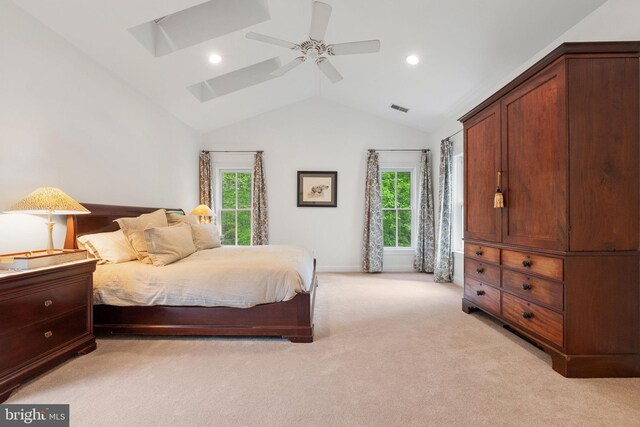 bedroom featuring ceiling fan, light carpet, recessed lighting, visible vents, and lofted ceiling with skylight