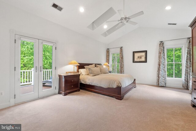 bedroom featuring multiple windows, access to outside, and light colored carpet