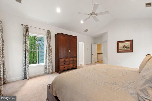 bedroom featuring baseboards, visible vents, light carpet, and vaulted ceiling