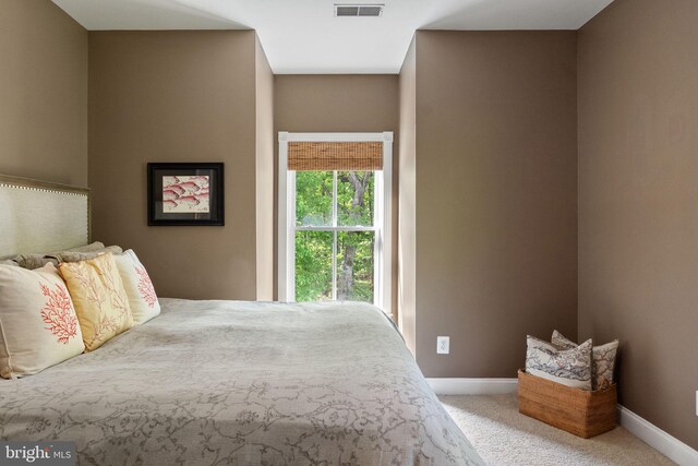 bedroom with visible vents, carpet flooring, and baseboards