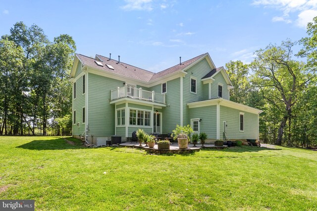 back of house with a yard, a patio, central AC, and a balcony