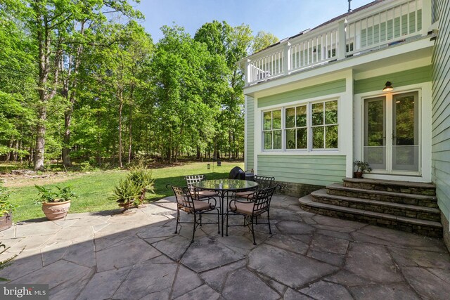 view of patio / terrace with outdoor dining area, a balcony, and entry steps