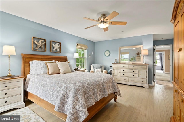 bedroom with light wood-style flooring and a ceiling fan