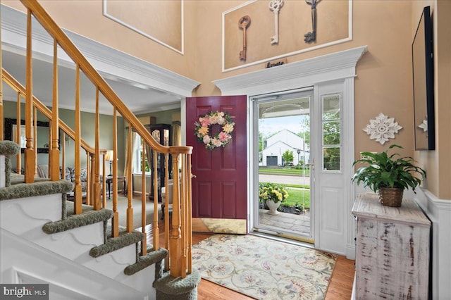 entrance foyer featuring wood finished floors and stairs