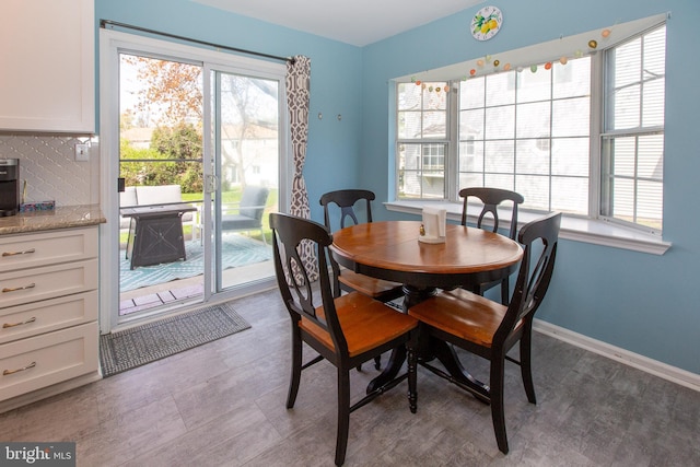 dining space with healthy amount of natural light and baseboards