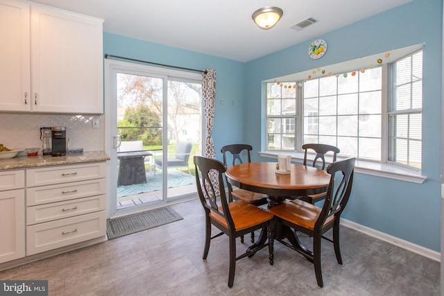 dining area featuring plenty of natural light and baseboards