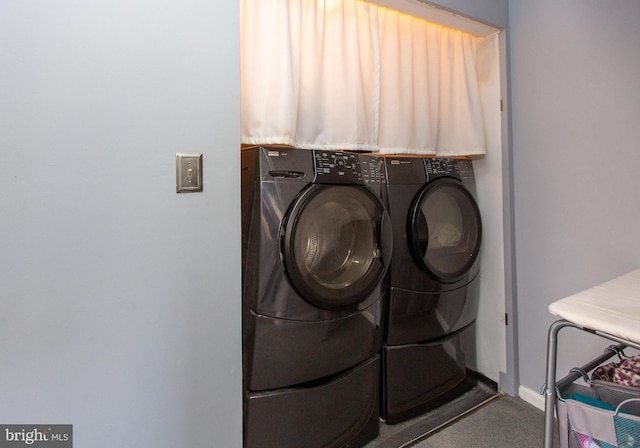 clothes washing area featuring washing machine and dryer and carpet flooring