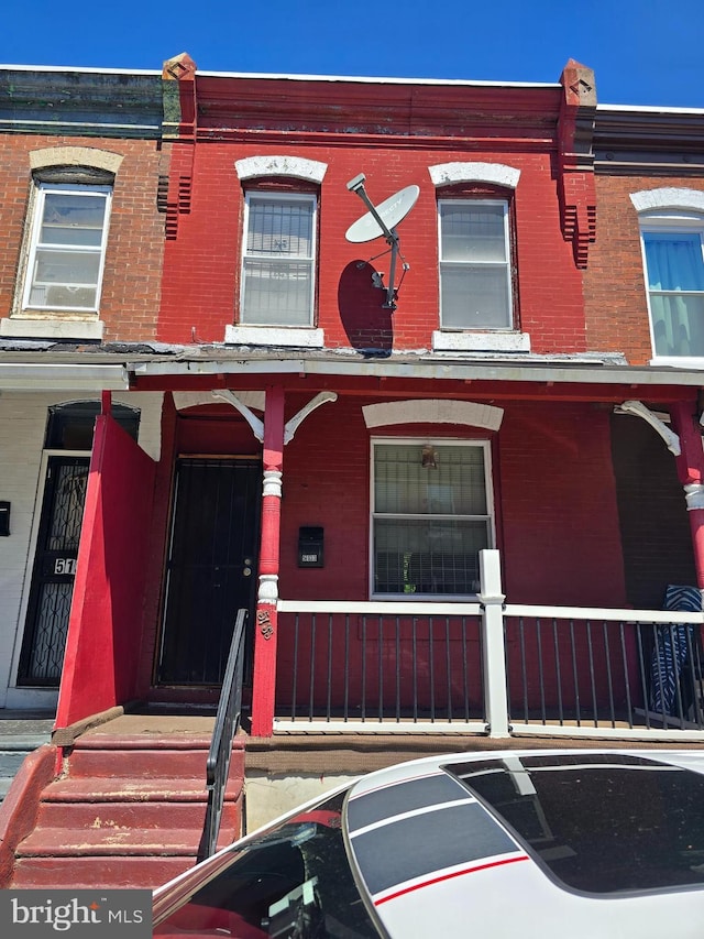 5133 Reno St, Philadelphia, PA 19139 - view of property featuring a porch and brick siding