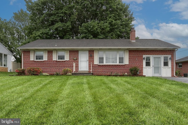 617 W Main St, Hummelstown, PA 17036 - view of front facade with brick siding, a chimney, a front lawn, cooling unit, and roof with shingles