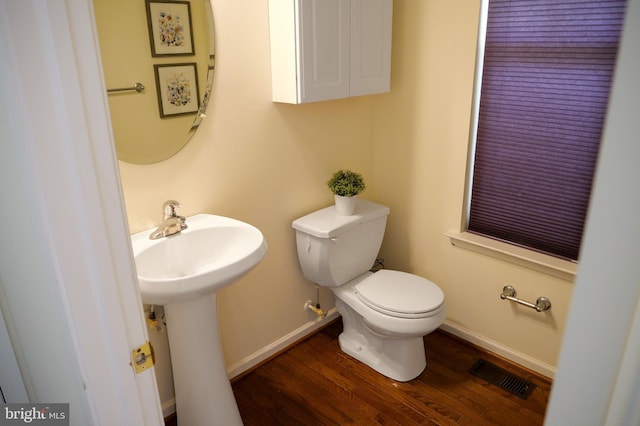 2725 Shelburne Rd, Downingtown, PA 19335 - half bath featuring a sink, toilet, baseboards, wood finished floors, and visible vents